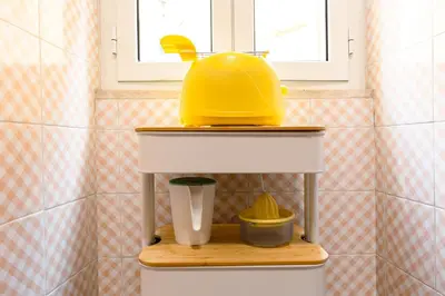 a yellow helmet on top of a kitchen sink at Orange Nest in Rome
