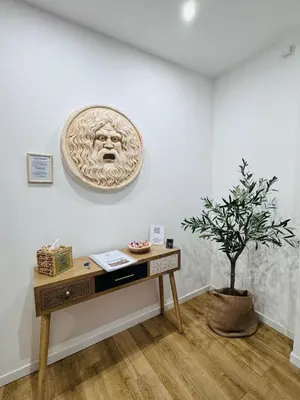 a room with a table and a plant on a wall at Roman Location San Pietro in Rome