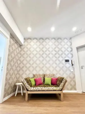 a living room with a couch with colorful pillows at Doria home-Saint Peter's View in Rome