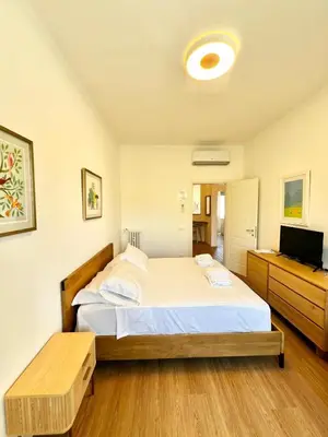 a bedroom with two beds and a flat screen tv at Doria home-Saint Peter's View in Rome