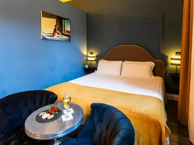 a hotel room with a bed and two chairs at JB Relais- Campo de' Fiori in Rome