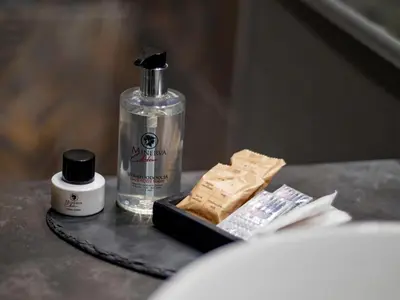 a table with a soap dispenser and a bottle of soap at JB Relais- Campo de' Fiori in Rome