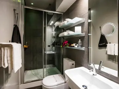 a bathroom with a shower and a toilet and a sink at JB Relais- Campo de' Fiori in Rome