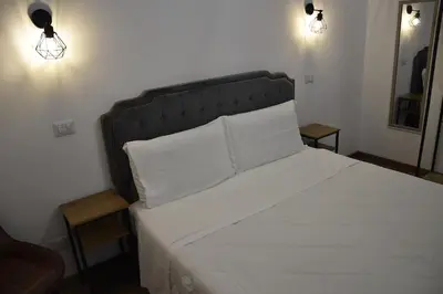 a bedroom with a large bed with two white pillows at Roma Chic Cattolica Gemelli in Rome