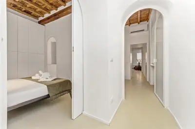 a hallway with white walls and white floors and ceilings at 4BNB - Luxury Navona Apartment in Rome