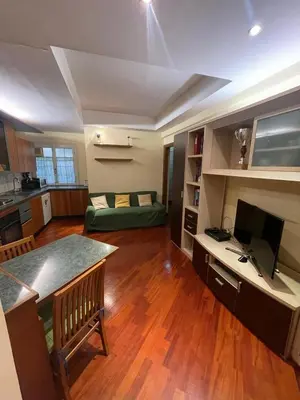a kitchen and living room with a desk and a television at Gaio Melisso Home in Rome