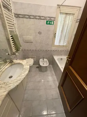 a bathroom with a sink and a toilet and a tub at Gaio Melisso Home in Rome
