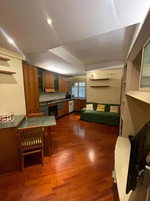 a large kitchen with a table and a couch at Gaio Melisso Home in Rome