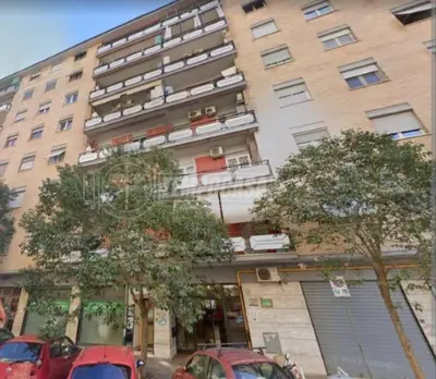 a large building with cars parked in front of it at Gaio Melisso Home in Rome