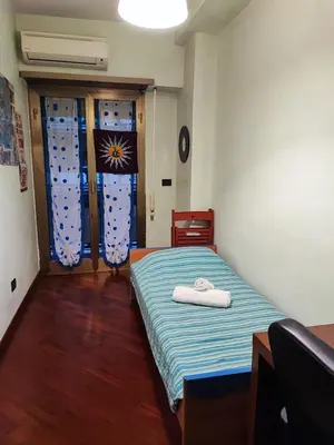a bedroom with a bed with two towels on it at Gaio Melisso Home in Rome