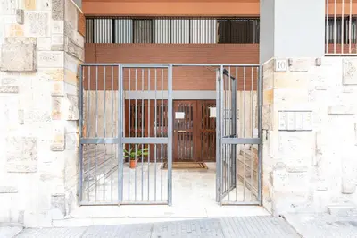 an entrance to a building with a metal gate at Maisonette Trastevere Wonderful Apartment - Top Collection in Rome