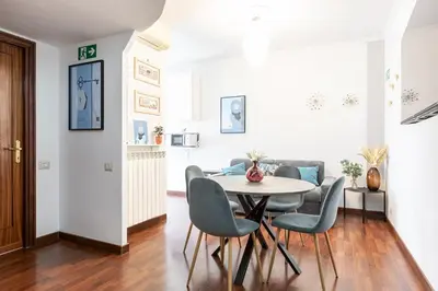 a dining room and living room with a table and chairs at Maisonette Trastevere Wonderful Apartment - Top Collection in Rome