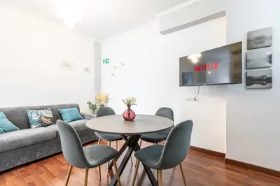 a living room with a couch and a table and chairs at Maisonette Trastevere Wonderful Apartment - Top Collection in Rome