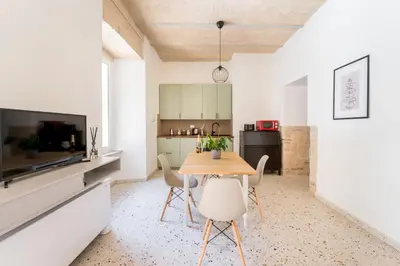 a kitchen and dining room with a table and chairs at FAMM - Cozy flat in Trastevere in Rome
