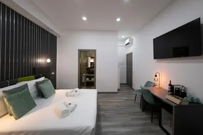 a hotel room with a bed and a desk at Trastevere Luxury Rooms in Rome