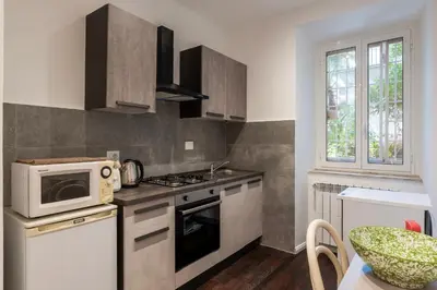 a kitchen with a microwave and a stove top oven at GuestHost - Sant'Agnese & Nomentana Cozy Apartment in Rome