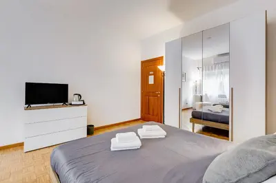 a bedroom with a bed with two towels on it at DAMA PROPERTY - Trastevere Homestay in Rome