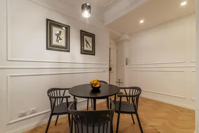 a dining room with a table and chairs at Toscana 2bis - FromHometoRome in Rome