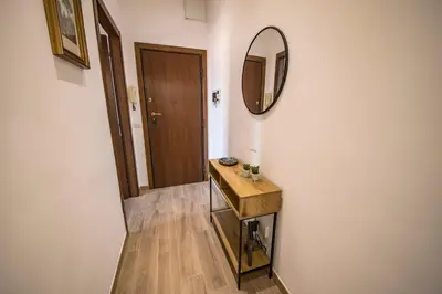 a hallway with a mirror and a wooden table at Roof Terrace Sophie, Repubblica apartment Termini Station in Rome