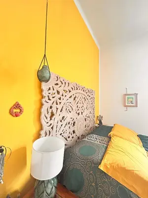 a bedroom with a bed and a yellow wall at Everlasting Zen Home in San Giovanni Rome in Rome