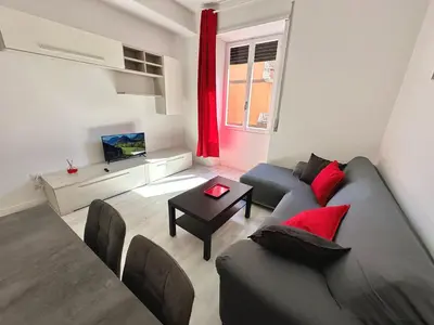 a living room with a couch and a tv at St Pietro city center near subway in Rome