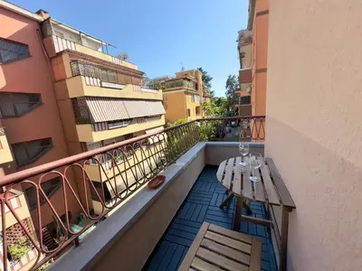 a balcony with a table and chairs on a building at St Pietro city center near subway in Rome