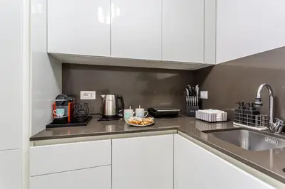a kitchen with white cabinets and a plate of food at iFlat Cozy and Elegant apt near Spanish Steps in Rome