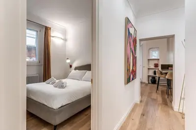 a bedroom with a bed and a desk in a room at 3 bedroom apartment Via Genova Monti area in Rome