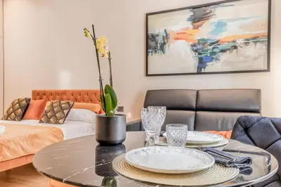 a living room with a table and a couch at Augusto Imperatore Luxury Suite in Rome