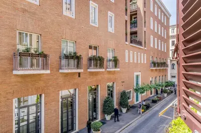 an apartment building with plants on the balconies at Augusto Imperatore Luxury Suite in Rome