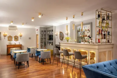 a restaurant with tables and chairs and a bar at Hotel Mozart in Rome