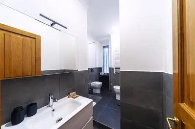 a bathroom with a white sink and a toilet at Flaminio District Holiday Home in Rome