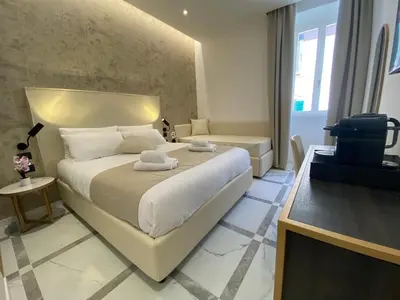 a bedroom with a large white bed in a room at Suite Croce in Rome