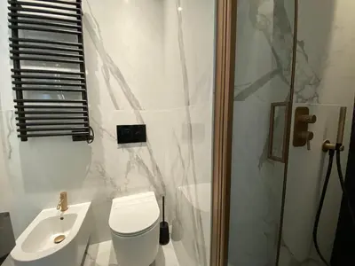 a bathroom with a toilet and a sink and a shower at Suite Croce in Rome