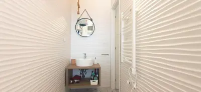 a bathroom with a sink and a mirror on a wall at Cheerful flat in funky Rome in Rome