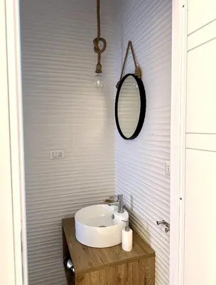 a bathroom with a sink and a mirror at Cheerful flat in funky Rome in Rome
