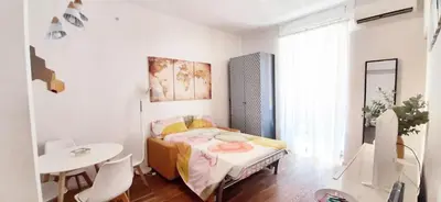 a small bedroom with a bed and a table at Cheerful flat in funky Rome in Rome