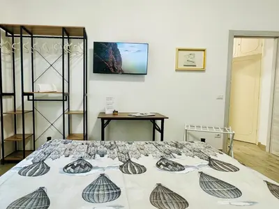 a bedroom with a bed with a comforter on it at Casa Flora in Rome