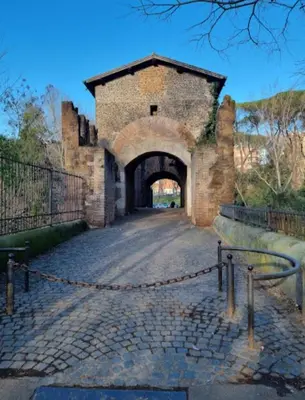an old brick building with a gate and a tunnel at Casa Flora in Rome