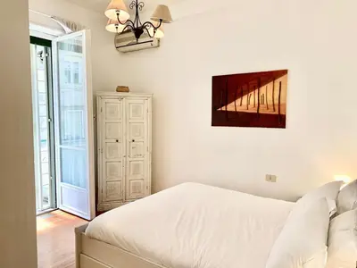 a bedroom with a bed and a painting on the wall at RomeAsYouLike - Trastevere Experience 20 in Rome