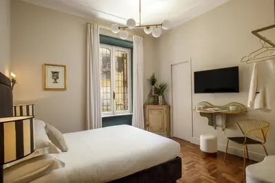 a bedroom with a bed and a tv on the wall at Daplace - Lavinia Apartment in Rome