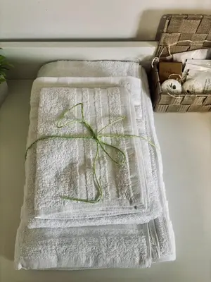 a white towel with a green bow on it at Domus Farnesina Ponte Milvio in Rome