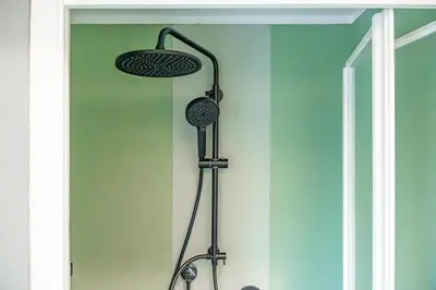 a shower with two lights on a wall at Domus Farnesina Ponte Milvio in Rome