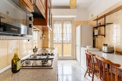 a kitchen with a stove and a counter top at Green Holiday Penthouse in Rome