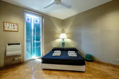 a bedroom with a bed with towels on it at PIRAMIDE SHABBY by Casa e Lode - colosseum, air conditioning in Rome