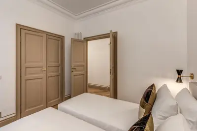 a living room with a white couch and a closet at Essenze eleganti a Trastevere in Rome
