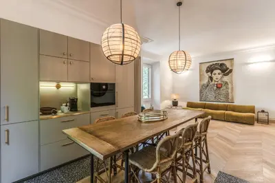 a kitchen and dining room with a table and chairs at Essenze eleganti a Trastevere in Rome