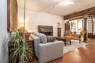 a living room with a couch and a fireplace at Suite Benedetta - Trastevere Luxury in Rome