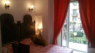 a bedroom with a bed and a large window at Vatican Leone IV in Rome