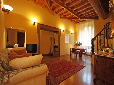 a living room with a couch and a dining room at Domus Navona Pantheon in Rome